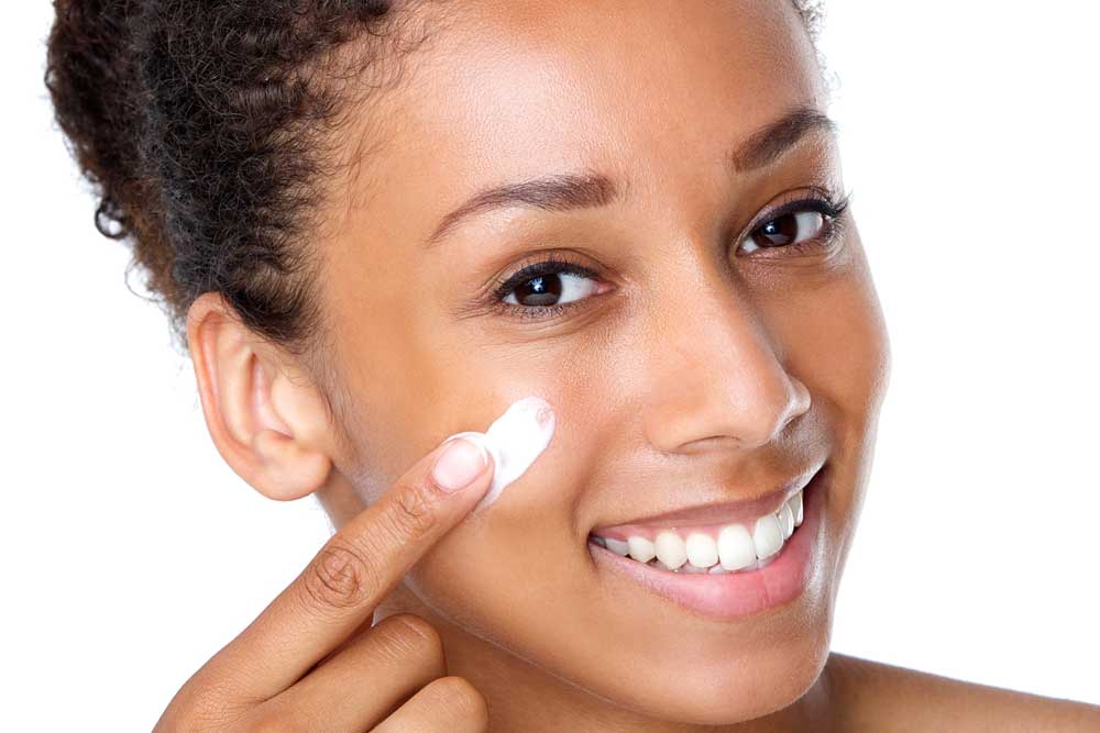 black woman treating acne with medication